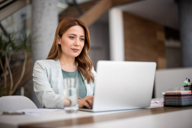 Woman at laptop with analytics dashboard