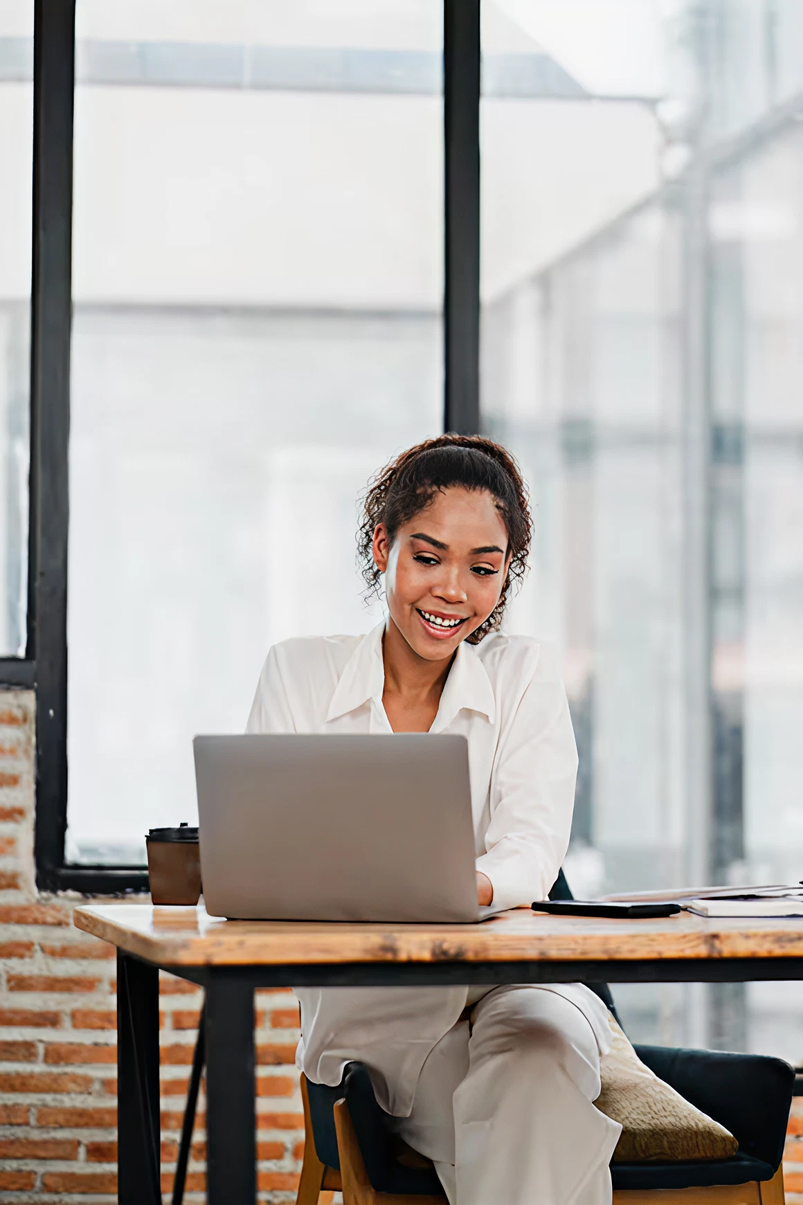 Woman smiling while using laptop