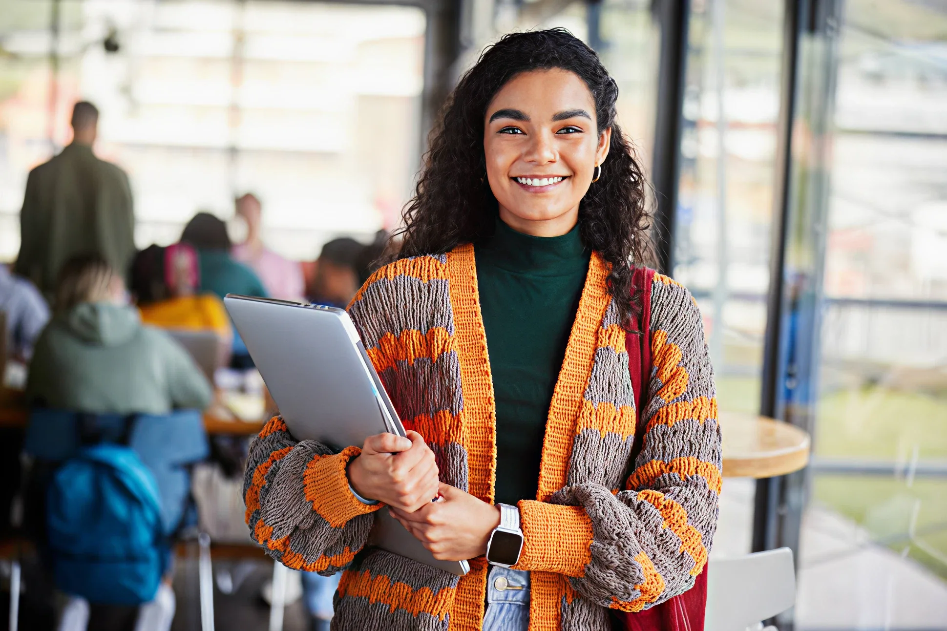 Woman smiling holding a tablet